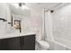 Bright bathroom featuring a modern vanity, stylish mirror, and a shower-tub combination with white tile at 3709 Tejon St, Denver, CO 80211
