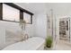Serene bathroom with a freestanding tub, marble walls, and a glass shower, creating a spa-like retreat at 3709 Tejon St, Denver, CO 80211