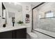 Elegant bathroom featuring marble tile, modern fixtures, and a glass-enclosed shower-tub combination at 3709 Tejon St, Denver, CO 80211