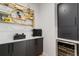 Stylish butler's pantry with black cabinetry, white counters, decorative shelving, and a wine fridge for entertaining at 3709 Tejon St, Denver, CO 80211