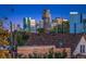 A view of the city skyline from a neighborhood with houses at 3709 Tejon St, Denver, CO 80211