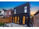 Modern home with striking black exterior, floor-to-ceiling windows, and outdoor patio at 3709 Tejon St, Denver, CO 80211