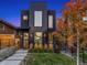 Modern home with dark exterior, striking architecture, and manicured front yard at 3709 Tejon St, Denver, CO 80211