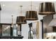 Modern kitchen features dark cabinets, oversized pendant lights, and stainless steel appliances at 3709 Tejon St, Denver, CO 80211