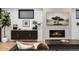 Cozy living room features a fireplace, modern decor, and lots of natural light at 3709 Tejon St, Denver, CO 80211