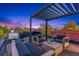 Relaxing rooftop deck with cozy lounge area, wooden furniture, and panoramic city and neighborhood views at 3709 Tejon St, Denver, CO 80211