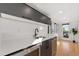 Modern wet bar with sleek cabinetry, stainless steel appliances, and hardwood floors at 3709 Tejon St, Denver, CO 80211