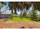 Secluded backyard with mature trees, a storage shed, and a well-maintained lawn, perfect for outdoor enjoyment at 7413 S Tamarac St, Centennial, CO 80112