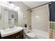 Well-lit bathroom with modern fixtures, tiled shower, and a stylish mirror with good lighting at 7413 S Tamarac St, Centennial, CO 80112