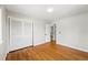 Hardwood floors and neutral walls create a simple and cozy bedroom with closet and bath access at 7413 S Tamarac St, Centennial, CO 80112
