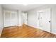 Bedroom with hardwood floors, access to ensuite bathroom, and closet offer ample storage space at 7413 S Tamarac St, Centennial, CO 80112