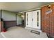 Inviting entryway with double doors and brick accents, leading into a cozy home at 7413 S Tamarac St, Centennial, CO 80112