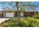 Lovely home featuring a brick facade, lush lawn, and attached garage, blending curb appeal with functionality at 7413 S Tamarac St, Centennial, CO 80112