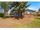 Charming home featuring a well-manicured front yard with mature trees and landscaping at 7413 S Tamarac St, Centennial, CO 80112