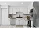 Bright, updated kitchen features white cabinets, stainless steel appliances, and undermount sink at 7413 S Tamarac St, Centennial, CO 80112