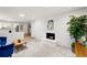 Open living room with fireplace and view of the kitchen at 7413 S Tamarac St, Centennial, CO 80112