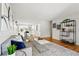 Bright living room with hardwood floors, a comfortable seating area, and stylish shelving at 7413 S Tamarac St, Centennial, CO 80112