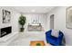 Bright living room offers a white brick fireplace, art and decor at 7413 S Tamarac St, Centennial, CO 80112
