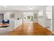 Bright living room with hardwood floors, built-in cabinets, and open access to the kitchen and dining areas at 7413 S Tamarac St, Centennial, CO 80112