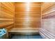 Inside the sauna, showcasing the wood construction, benches, and hot stones for relaxation at 7413 S Tamarac St, Centennial, CO 80112