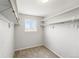 Spacious walk-in closet with a window, shelving, and ample space for organized storage at 7413 S Tamarac St, Centennial, CO 80112