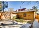 Charming backyard with wooden fence, spiral staircase and lush green grass at 3122 Perry St, Denver, CO 80212