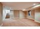 Finished basement area with stairs, closet, window and neutral colored carpet at 3122 Perry St, Denver, CO 80212