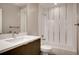 Bathroom featuring a shower-tub combo, modern sink, vanity and contemporary fixtures, perfect for relaxation and convenience at 3122 Perry St, Denver, CO 80212