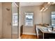 Elegant bathroom featuring a glass-enclosed shower, dual sink vanity, and a well-lit window offering both style and functionality at 3122 Perry St, Denver, CO 80212