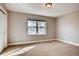 Cozy bedroom with a large window offering natural light, and neutral carpet creating a serene and inviting atmosphere at 3122 Perry St, Denver, CO 80212