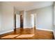 Spacious bedroom featuring hardwood floors, complemented by neutral walls and multiple doorways, offering a versatile layout at 3122 Perry St, Denver, CO 80212