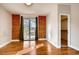 Bright bedroom with exposed brick wall, sliding glass doors and access to a closet, filled with natural light at 3122 Perry St, Denver, CO 80212