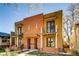 Contemporary townhome showcasing brick facade, private balconies, and sleek architectural design at 3122 Perry St, Denver, CO 80212