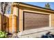 Detached one car garage with brown garage door and side yard access at 3122 Perry St, Denver, CO 80212