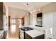 Modern kitchen featuring an oven, stove, and stainless steel appliances, seamlessly flowing into an open-concept living area at 3122 Perry St, Denver, CO 80212