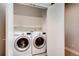 Convenient laundry room equipped with a washer, dryer, and shelving, offering practicality and organization at 3122 Perry St, Denver, CO 80212