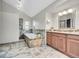 Luxurious bathroom offers a soaking tub and vanity with wood cabinets at 3269 W 101St Cir, Westminster, CO 80031