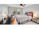 Cozy bedroom with a wooden headboard, desk with globe and chair, and natural light streaming through the windows at 3269 W 101St Cir, Westminster, CO 80031