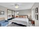 Bedroom featuring a bed with a striped comforter, neutral walls, and a closet with mirrored doors at 3269 W 101St Cir, Westminster, CO 80031