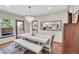 Elegant dining room with a chandelier, large mirror, and seamless transition to the living area at 3269 W 101St Cir, Westminster, CO 80031