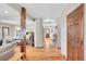 Bright entryway featuring hardwood floors, natural light, and views into adjacent living spaces at 3269 W 101St Cir, Westminster, CO 80031