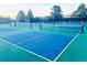 Multiple outdoor pickleball courts with a vibrant blue and green color scheme available in the community at 3269 W 101St Cir, Westminster, CO 80031