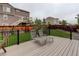 Backyard deck with lounge chairs, green grass and privacy fence, perfect for relaxation and outdoor entertainment at 9250 Rifle St, Commerce City, CO 80022