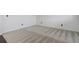 Spacious basement area featuring neutral carpeting and baseboards, offering a versatile space for various uses at 9250 Rifle St, Commerce City, CO 80022