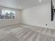 Bright bedroom featuring neutral walls, plush carpeting, and a window offering a glimpse of the outdoors at 9250 Rifle St, Commerce City, CO 80022