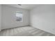 Bright bedroom featuring neutral carpet, a window with blinds, and light-colored walls, offering a calm and inviting space at 9250 Rifle St, Commerce City, CO 80022