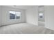 Bright, spacious bedroom with plush carpeting, large window, and ample natural light at 9250 Rifle St, Commerce City, CO 80022