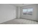 Bedroom featuring a window, neutral carpet, and a door, creating a blank canvas for customization at 9250 Rifle St, Commerce City, CO 80022