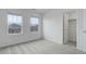 Bright bedroom with two windows, neutral carpet, and a closet for storage at 9250 Rifle St, Commerce City, CO 80022