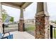 Charming front porch featuring decorative stone pillars and a cozy seating area, perfect for enjoying the neighborhood view at 9250 Rifle St, Commerce City, CO 80022